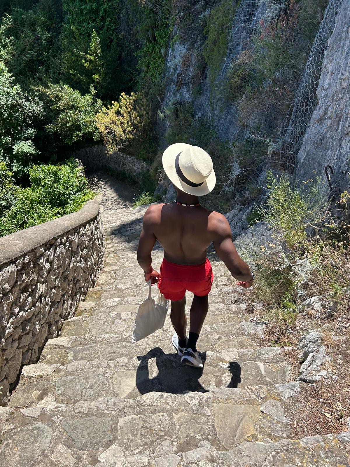 Daniel Esambu walking down stone steps, travel
